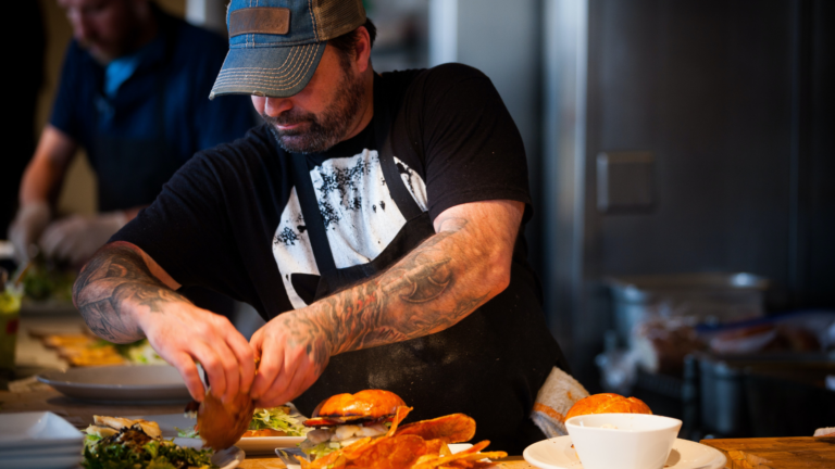 Chef preparing a burger.